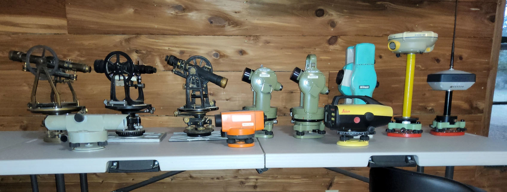 Collection of vintage and modern surveying instruments.